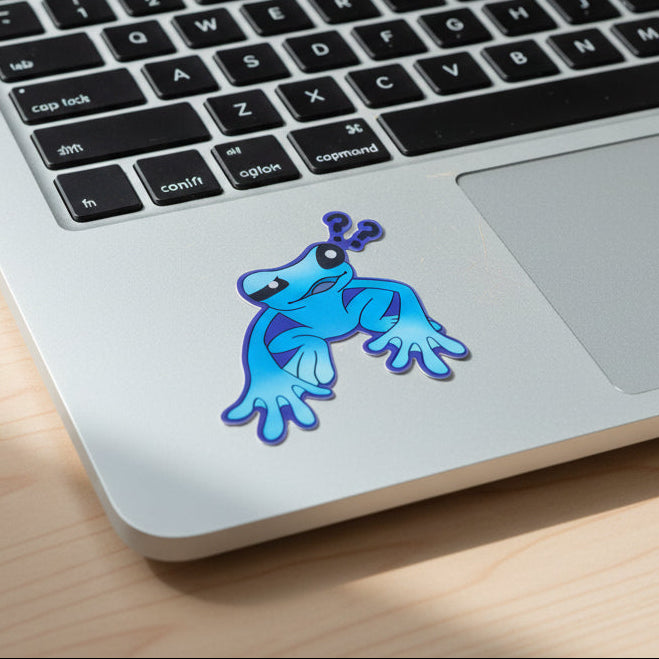Blue cartoon frog sticker on a keyboard of a laptop 