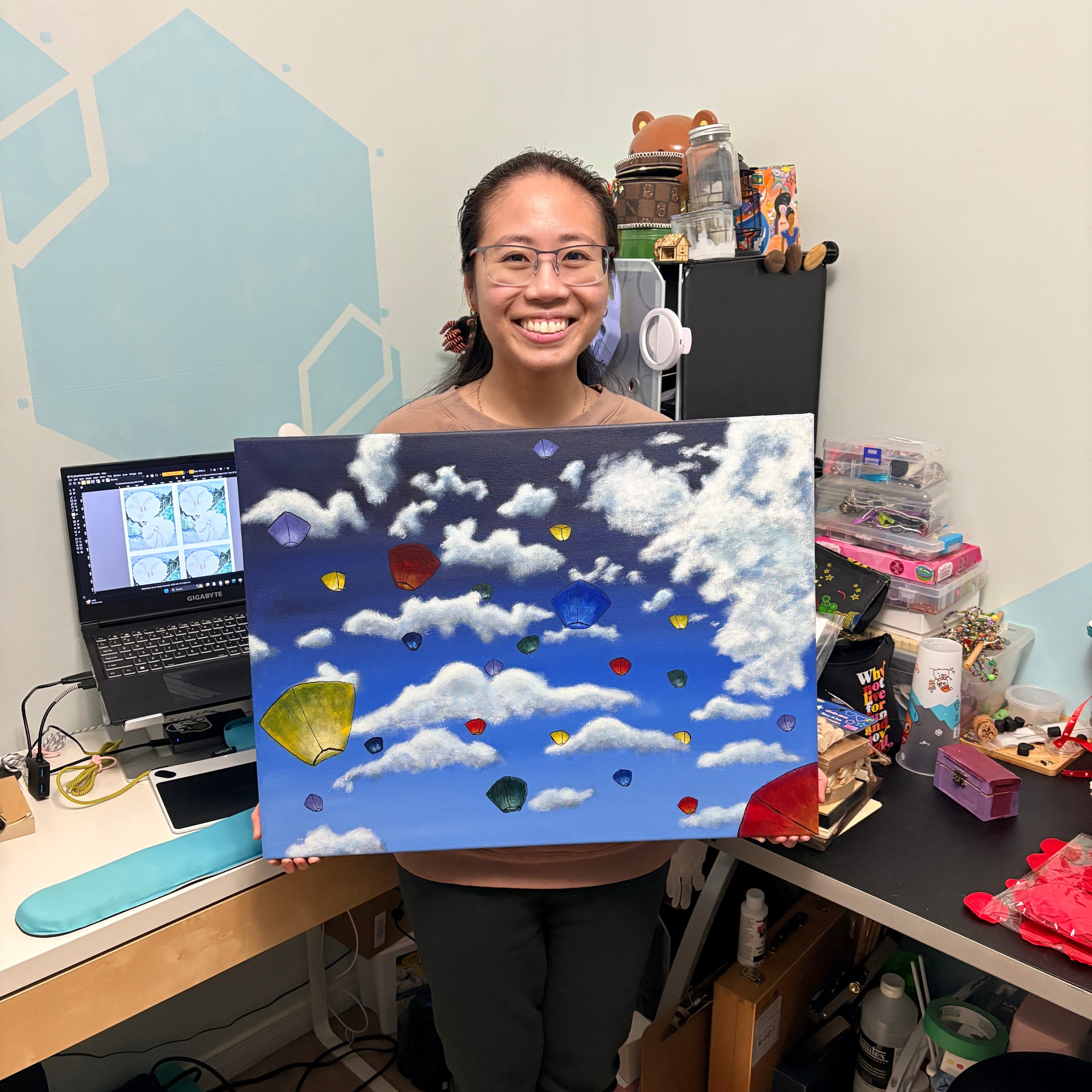 Jessie holding original lanterns in the sky artwork