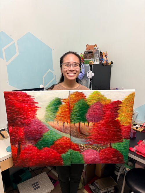 Person standing next to a colorful abstract painting indoors.