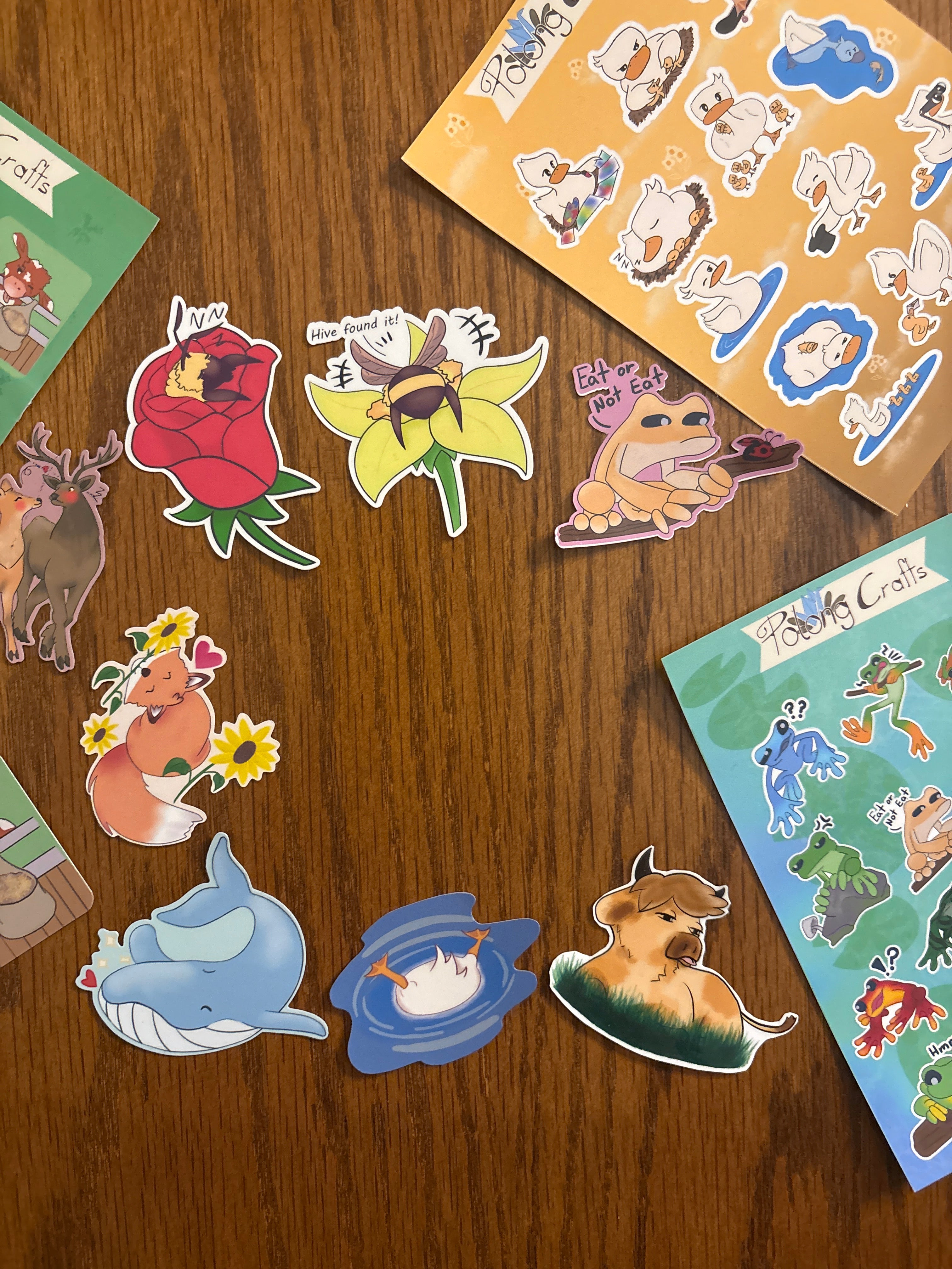 Collection of colorful animal stickers on a wooden surface