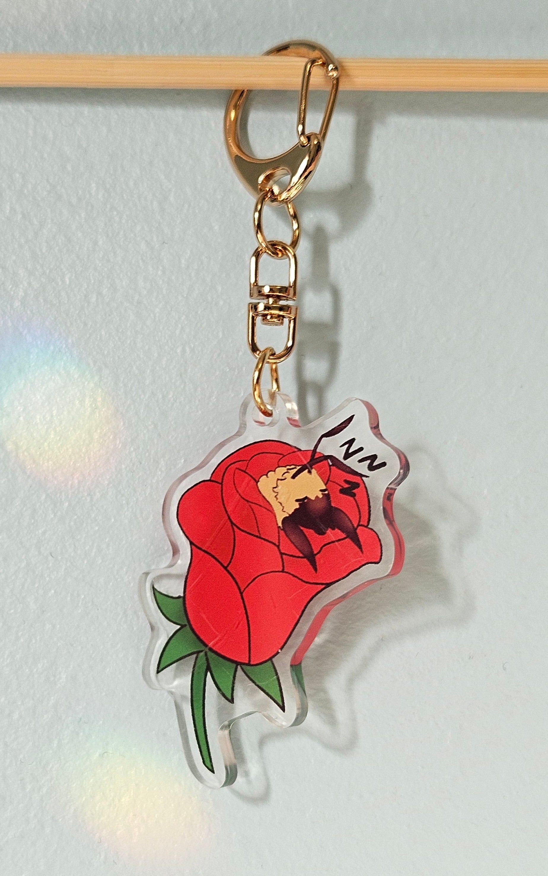 Keychain with a red rose design on a white background