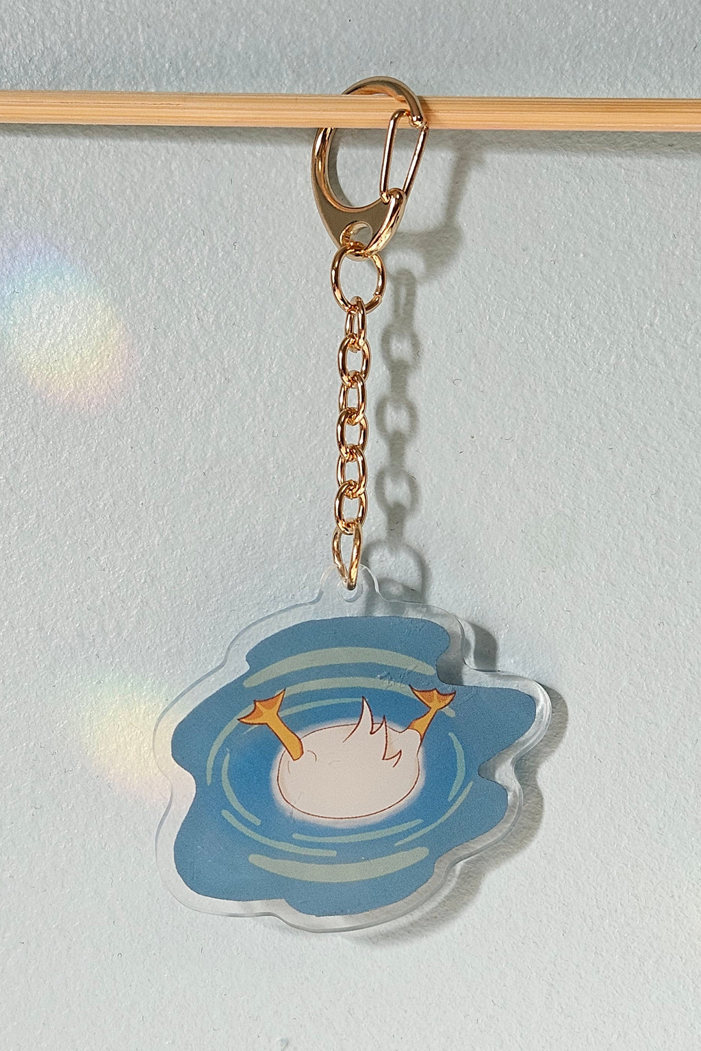 Decorative keychain with a cartoon character on a light gray background