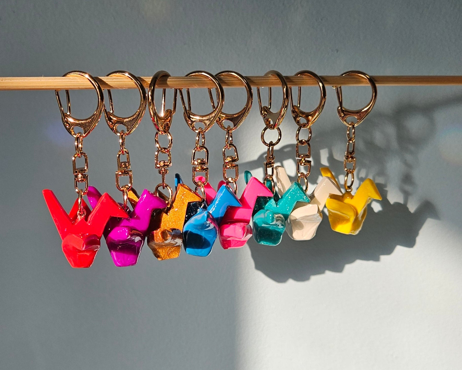Colorful keychains on a stick against a gray background