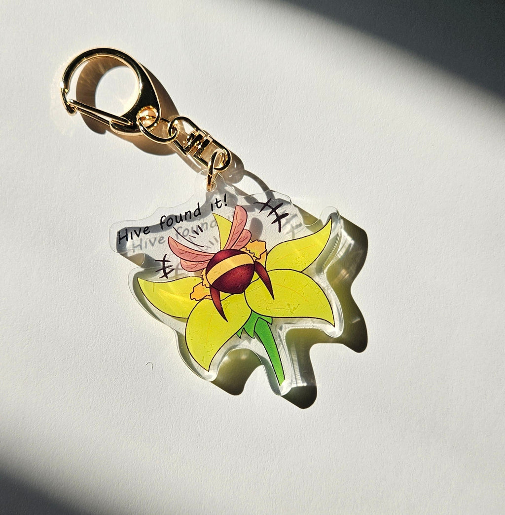 Flower-shaped keychain charm on a dark background