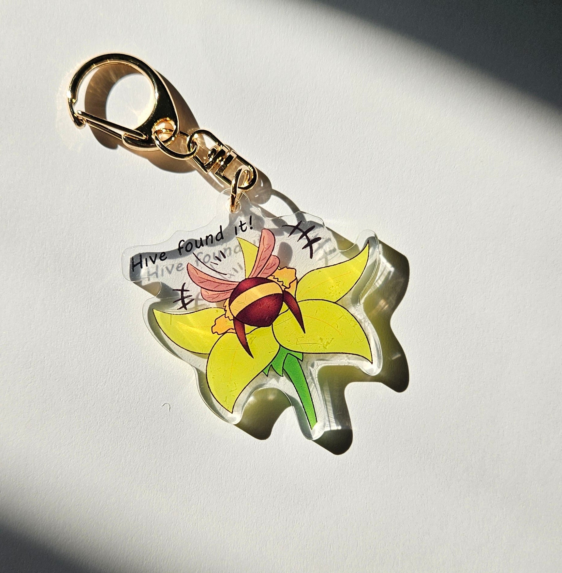 Flower-shaped keychain charm on a dark background