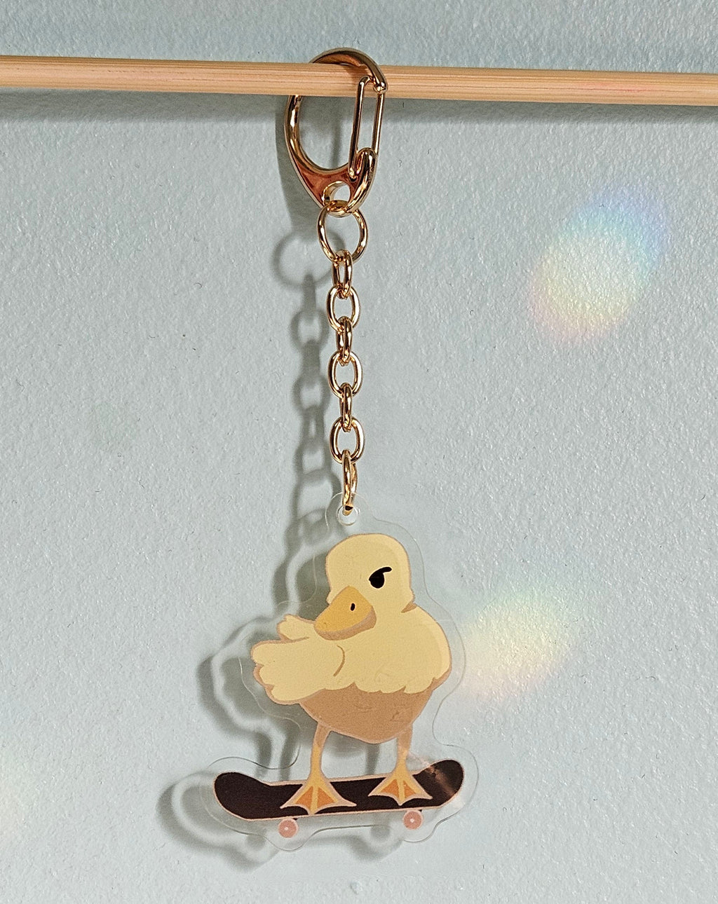 Keychain with a duck design on a light blue background