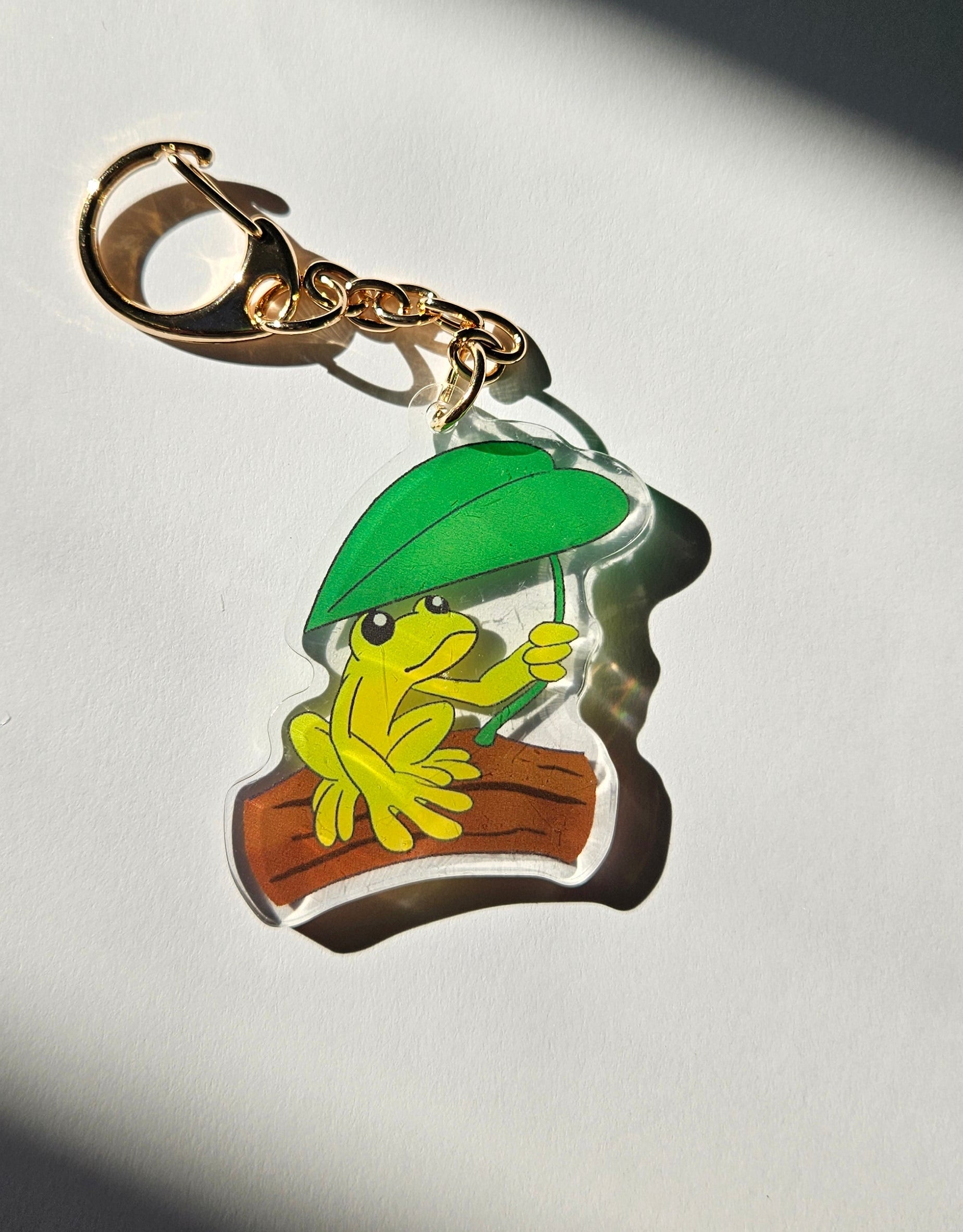 Colorful keychain with a design of a leaf and flowers on a white background